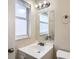 Bathroom vanity with a new mirror, window and brushed nickel fixtures at 1602 Sheffield Rd, Leesburg, FL 34748