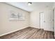 This bedroom has a window, a closet, and laminate flooring at 1602 Sheffield Rd, Leesburg, FL 34748