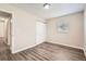 Neutral bedroom with a window for natural light, closet and wood-look flooring at 1602 Sheffield Rd, Leesburg, FL 34748