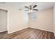 Bedroom featuring wood-look floors, ceiling fan, window with blinds, and neutral wall color at 1602 Sheffield Rd, Leesburg, FL 34748