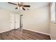 Bedroom with a ceiling fan, closet, and wood-look floors, offering a comfortable and stylish space at 1602 Sheffield Rd, Leesburg, FL 34748