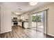 Updated kitchen with white cabinets, stainless steel appliances, and a sliding glass door to the backyard at 1602 Sheffield Rd, Leesburg, FL 34748