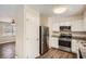 Kitchen view with stainless steel appliances and white cabinets at 1602 Sheffield Rd, Leesburg, FL 34748
