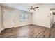 Bright and airy living room features wood floors, a ceiling fan, and natural light at 1602 Sheffield Rd, Leesburg, FL 34748