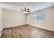 Bright living room with wood floors, ceiling fan and a front door view at 1602 Sheffield Rd, Leesburg, FL 34748