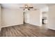 Spacious living room featuring wood floors that flow into the kitchen area at 1602 Sheffield Rd, Leesburg, FL 34748