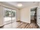 Bright living room featuring a sliding glass door to the patio and modern wood-look flooring at 1602 Sheffield Rd, Leesburg, FL 34748