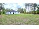 Expansive backyard featuring a modern home with sliding glass doors, perfect for outdoor living at 16908 Sw 44Th Cir, Ocala, FL 34473