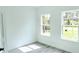 Bright bedroom featuring luxury vinyl plank flooring, and two windows bringing in plenty of natural light at 16908 Sw 44Th Cir, Ocala, FL 34473