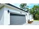 View of a well maintained homes garage and address number with gray accents and white walls at 16908 Sw 44Th Cir, Ocala, FL 34473