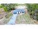 Aerial view of a single-Gathering home with a two car garage, brick driveway, and manicured lawn at 16908 Sw 44Th Cir, Ocala, FL 34473