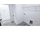 Laundry room with gray wood flooring, washer hookups, and white wire shelving at 16908 Sw 44Th Cir, Ocala, FL 34473