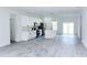 Open-concept living space featuring a modern kitchen with stainless steel appliances and light gray wood floors at 16908 Sw 44Th Cir, Ocala, FL 34473