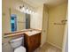 Bathroom featuring a well-lit vanity, mirror, and neutral tile floor at 1695 Lee Rd # E214, Winter Park, FL 32789