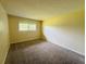 Bedroom with neutral walls, carpet, and natural light at 1695 Lee Rd # E214, Winter Park, FL 32789