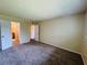 Spacious bedroom featuring neutral walls, carpet, and easy access to a walk-in closet and bathroom at 1695 Lee Rd # E214, Winter Park, FL 32789