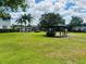 A charming gazebo on a verdant lawn, surrounded by palm trees and building in the community at 1695 Lee Rd # E214, Winter Park, FL 32789