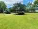 Community green space featuring a gazebo surrounded by a large grassy area and shade trees at 1695 Lee Rd # E214, Winter Park, FL 32789