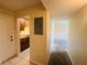 Hallway view of a kitchen, an open door, and carpet flooring at 1695 Lee Rd # E214, Winter Park, FL 32789