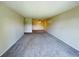 Spacious carpeted living room offers ample space for furniture with neutral paint and a ceiling fan at 1695 Lee Rd # E214, Winter Park, FL 32789