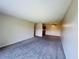 A spacious living room features neutral colored walls and carpet at 1695 Lee Rd # E214, Winter Park, FL 32789