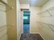 Walk-in closet features shelving and neutral walls and access to bedroom at 1695 Lee Rd # E214, Winter Park, FL 32789