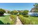 Well-manicured backyard with decorative stone pathway, lush greenery, and privacy fence for a tranquil outdoor experience at 17117 Cypress Preserve Pkwy, Orlando, FL 32820
