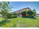 Beautifully landscaped backyard featuring lush lawn, mature trees, and vibrant flower beds providing a serene outdoor space at 17117 Cypress Preserve Pkwy, Orlando, FL 32820