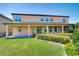 Large, grassy backyard featuring a well-maintained lawn, garden area and a two story home at 17117 Cypress Preserve Pkwy, Orlando, FL 32820