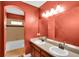 Bathroom has dual sink vanity with an arched entry to the separate shower and toilet area at 17117 Cypress Preserve Pkwy, Orlando, FL 32820