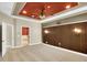 Spacious bedroom featuring wood accent wall and tray ceiling with fan at 17117 Cypress Preserve Pkwy, Orlando, FL 32820
