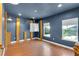 Nautical themed bedroom with hardwood floors, wooden posts, and two windows providing ample natural light at 17117 Cypress Preserve Pkwy, Orlando, FL 32820