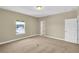 Bedroom featuring carpet flooring, neutral walls, a window, and an interior door at 17117 Cypress Preserve Pkwy, Orlando, FL 32820