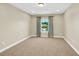 Spacious bedroom with carpet flooring, neutral walls, and a window letting in natural light at 17117 Cypress Preserve Pkwy, Orlando, FL 32820