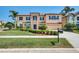 Stunning two-story home with a stone-accented facade, well-manicured lawn, and lush landscaping at 17117 Cypress Preserve Pkwy, Orlando, FL 32820