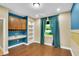 Bright home office with built-in shelving, desk space, and window overlooking the backyard at 17117 Cypress Preserve Pkwy, Orlando, FL 32820