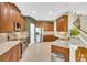 Spacious kitchen featuring stainless steel appliances, granite countertops, and rich wood cabinetry at 17117 Cypress Preserve Pkwy, Orlando, FL 32820