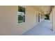 Covered patio with concrete floor extends along the rear of the home, with several windows and doors at 17117 Cypress Preserve Pkwy, Orlando, FL 32820