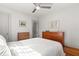 Bright bedroom with ceiling fan, hardwood floors, a clean white bed, and well-lit with two dressers at 210 E Kaley St, Orlando, FL 32806