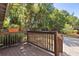 A view of the deck, with a wooden fence and lots of green plants and trees in the background at 210 E Kaley St, Orlando, FL 32806