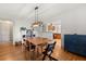 Dining area with hardwood floors, modern lighting, and adjacent access to the kitchen at 210 E Kaley St, Orlando, FL 32806