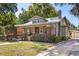Charming home with a brick chimney, well manicured lawn and mature landscaping at 210 E Kaley St, Orlando, FL 32806