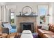 Living room featuring a brick fireplace with a mantel and windows on either side at 210 E Kaley St, Orlando, FL 32806