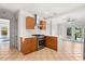 Well-lit kitchen with a stainless steel stove, hood vent, and view of the living room at 210 E Kaley St, Orlando, FL 32806