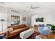 Cozy living room with modern ceiling fan, comfortable leather sofa, and bright natural light at 210 E Kaley St, Orlando, FL 32806