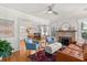 Open-concept living room featuring hardwood floors, fireplace, and comfortable seating at 210 E Kaley St, Orlando, FL 32806