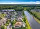 An aerial view of a neighborhood featuring beautiful homes, lush landscaping, and a serene lake in the background at 2145 Plantation Oak Dr, Orlando, FL 32824