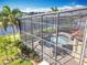 Aerial perspective of a screened pool and patio, overlooking a scenic canal and manicured landscaping at 2145 Plantation Oak Dr, Orlando, FL 32824