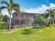 Beautiful backyard featuring a large screened in patio, lush lawn, and tropical landscaping at 2145 Plantation Oak Dr, Orlando, FL 32824