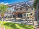 Spacious screened patio with a pool, dining area, and lush green lawn, creating an ideal outdoor oasis at 2145 Plantation Oak Dr, Orlando, FL 32824